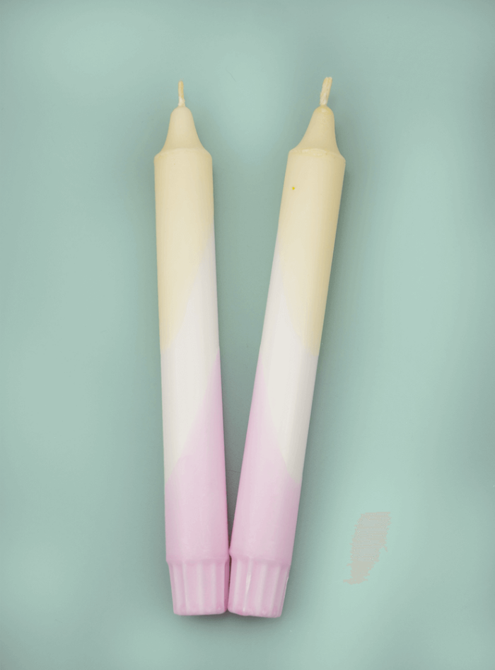 Two-colored candles in delicate yellow and pink